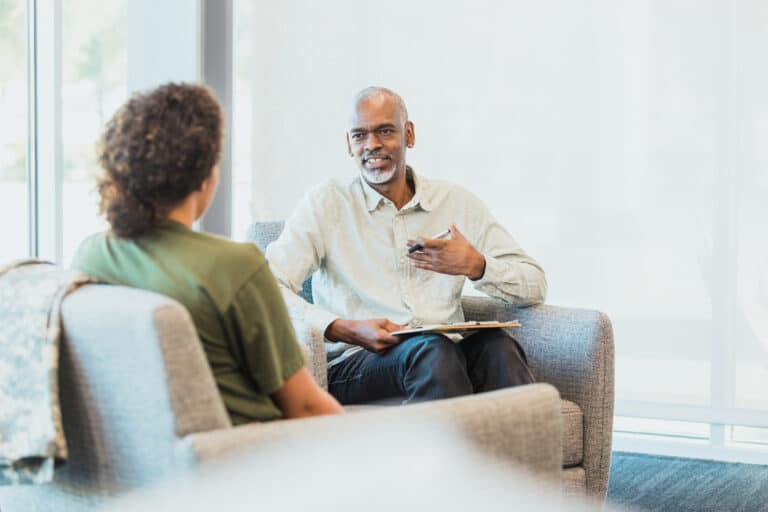 Two people sitting down and talking