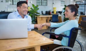 a man and a woman shaking hands and smiling