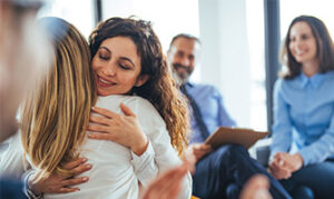 Two women hugging and smiling